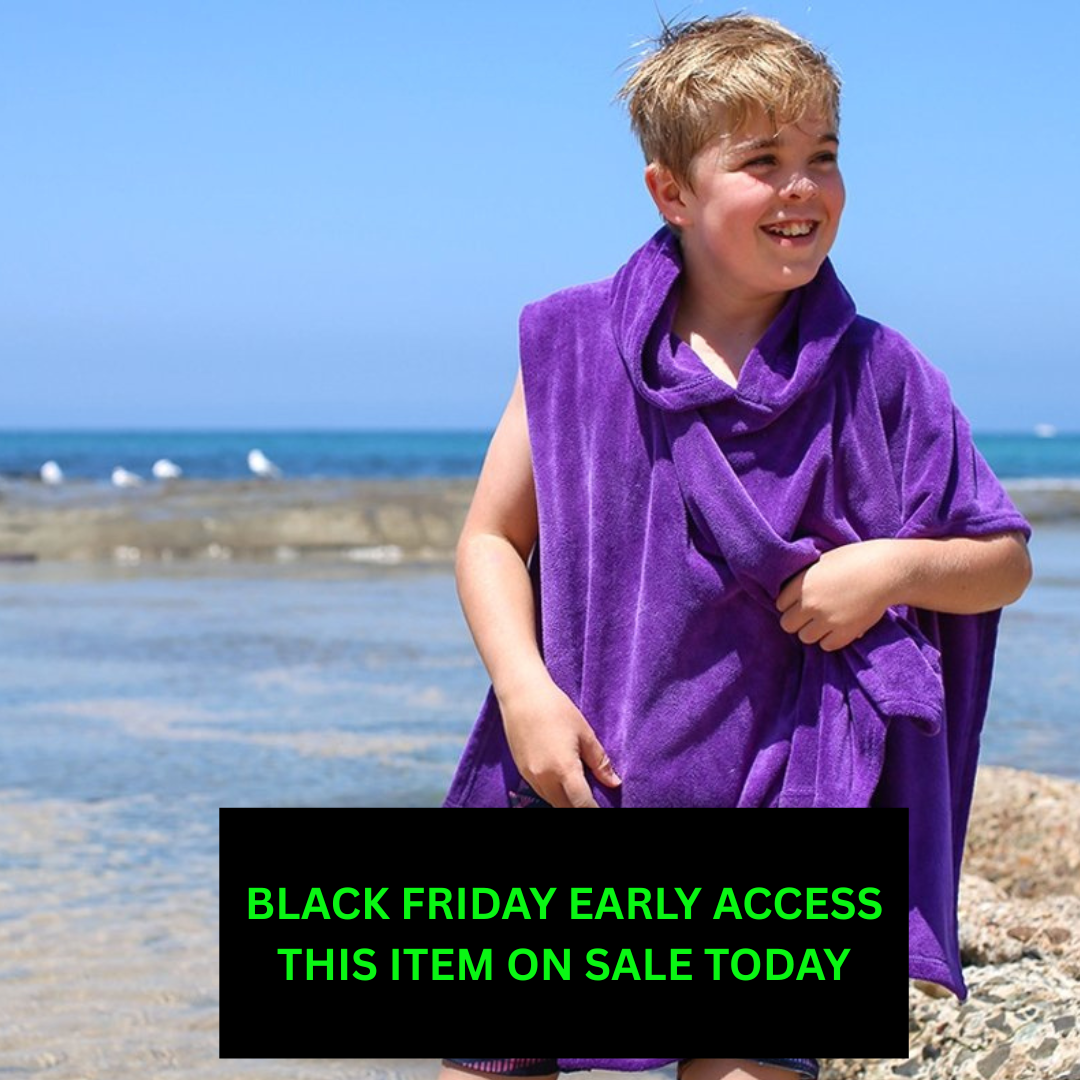 Child wearing a purple towel on a beach with a Black Friday text overlay.