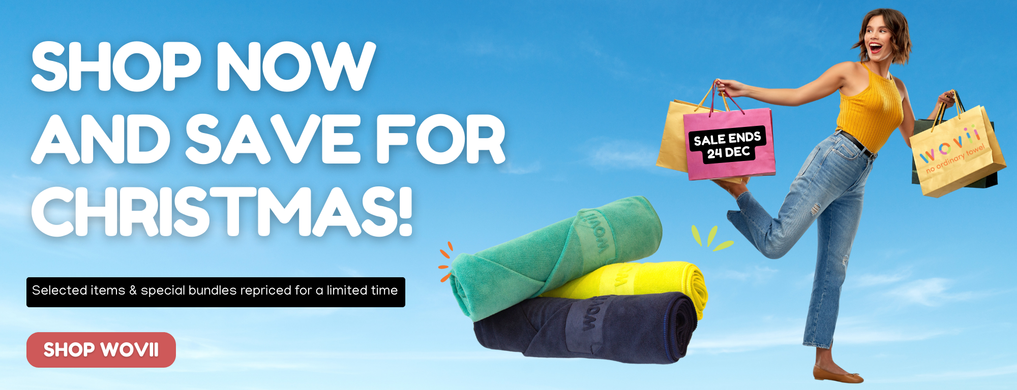 Promotional banner with a woman holding shopping bags, text encouraging Christmas shopping, and folded towels.